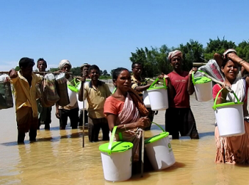 Affected people holding Oxfam buckets