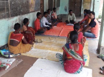 Meeting with community members to discuss the state of education in the village