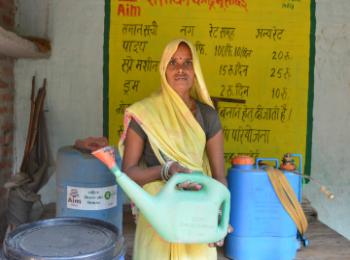 Manju Devi holding farming equipment