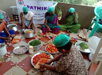 Women prepare food to be distributed during Project Pathik in Sira town in Tumkur