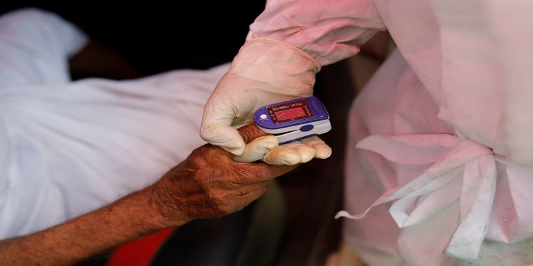 Health professional checks oxygen level of patient
