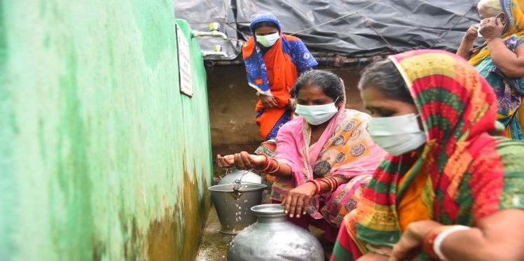 A woman happily drinks water from IRP tap in Talakokala village in Brahmagiri block. She said, after filtration water tastes good and she feels satisfied while drinking directly from the tap. 