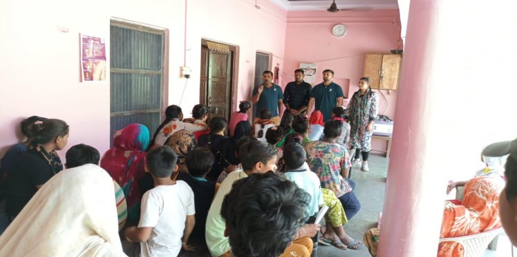 Community mobilizer giving information about Ration card scheme to sugarcane farmer