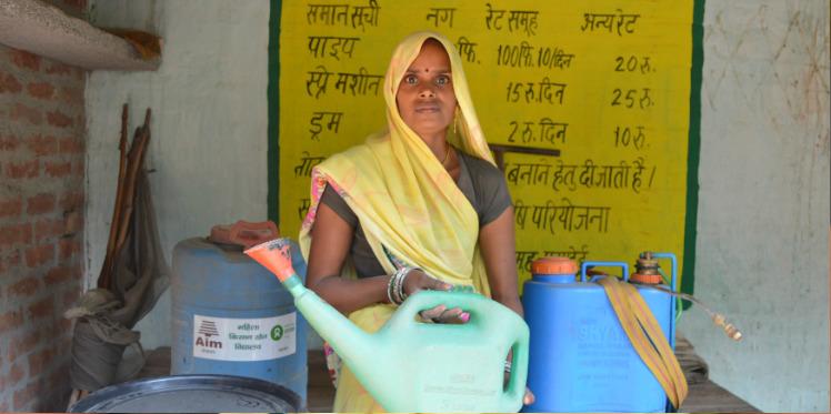 Manju Devi holding farming equipment