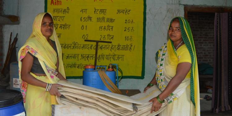 Manju Devi holding farming equipment
