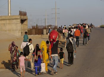 Migrant workers begin the long arduous journey back home